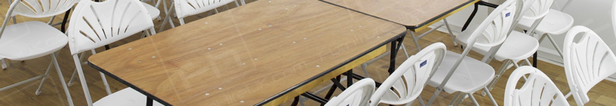 trestle tables and white folding chairs